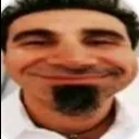 Serj Tankian with a wide, distorted smug grin and goatee.