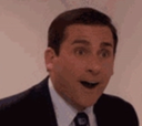 Man with dark hair and a suit jacket looking surprised with his mouth wide open.