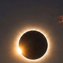 Solar eclipse showing a black moon silhouetted against the glowing sun corona.