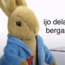 Peter Rabbit wearing a blue jacket looking sideways with text partially visible next to him.