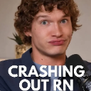 A man with curly hair looks into the camera with a wide-eyed, strained expression above the text CRASHING OUT RN.