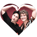 Zach Braff and Donald Faison forming a heart shape with their arms.