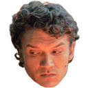 Man with curly hair looking sideways with a skeptical and judgmental expression.