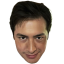A man with dark hair giving a smug, devilish smirk.