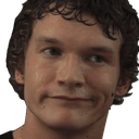 Man with curly hair making a smug, skeptical facial expression with pursed lips.