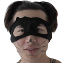 Person wearing a black cat mask with drawn-on whiskers and nose looking at the camera.