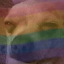 A distorted, low-quality close-up of a face with a rainbow flag overlay.