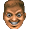 A man's face with wide, unblinking eyes and a large, toothy, mischievous grin.