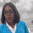 Woman wearing glasses pursing her lips and looking skeptical.
