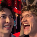 Two men with wide-eyed, screaming expressions of intense shock and excitement.