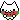 A pixelated white cat face happily chewing on a slice of watermelon.