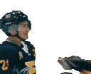 Hockey players in dark jerseys leaning in for a kiss during a celebratory moment.