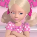 Barbie doll with blonde hair and a pink heart-patterned shirt looking annoyed with crossed arms and a side-eye expression.