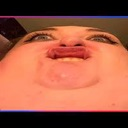 Face with an extreme fish-eye lens distortion making a puckered, silly expression.