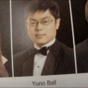 A young man with glasses wearing a tuxedo and bowtie in a formal yearbook portrait style.
