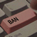 A close-up of a pink keyboard key with the word BAN printed in black text.