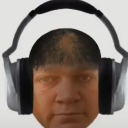 A man's head wearing large headphones with a blank, deadpan expression.