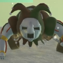 Jester character with a white mask and green and brown hat leaning forward with a mischievous expression.