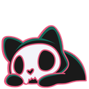 A black cat with a white skull face resting its head down with a sleepy expression.