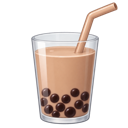 Bubble tea in a clear glass with dark tapioca pearls and a straw.