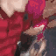 Two men kissing in a close-up, low-quality, meme-style photograph.