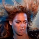 Beyoncé with her hair blowing in the wind, making a shocked and confused facial expression.