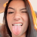 Charli D'Amelio winking and sticking her tongue out at the camera.