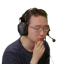 Man with glasses and a headset resting his chin on his hand while looking down in thought.