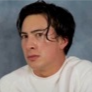 Man with a skeptical, side-eye expression looking directly at the camera.