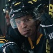 Hockey player wearing a helmet makes a skeptical, unimpressed face.