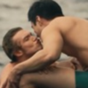 Two men leaning in closely toward each other as if about to kiss.