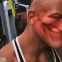 The Rock with a heavily distorted, wide, and smug grin.