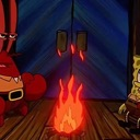 Mr. Krabs stands calmly in front of a small, flickering fire.