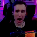 A man with a wide open mouth and shocked expression looking directly at the camera.
