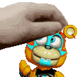 A human hand repeatedly pats the top of a colorful robot bear's head.