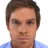 A man with a serious, intense expression stares directly forward.