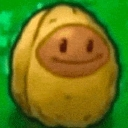A light brown, rounded nut character with a simple, happy, and content facial expression.
