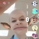 Person with a warped face filter and large elf ears looking directly at the camera.