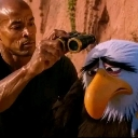 David Goggins holding binoculars while standing next to a grumpy-looking Mighty Eagle character.