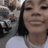 A person with a wide, bright smile captured in a close-up, distorted fish-eye lens effect.
