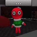 A small red character with wide, shocked eyes wearing a green and white Christmas sweater.