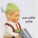A vintage doll wearing a green hat with the text uuu yaba yorar next to it.