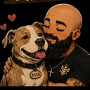 A bearded man with a shaved head is smiling while hugging a happy brown and white dog with hearts floating nearby.