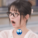 Woman with glasses looking shocked with a blue emoji face placed below her chin.