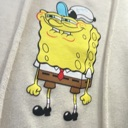 SpongeBob SquarePants making a smug and suspicious facial expression.