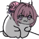 A small, round, gray creature with pink hair and a rose accessory sitting in a corner looking sad.