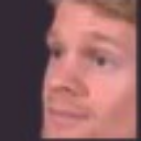 Man with blonde hair looking to the side with a confused and skeptical expression.