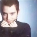 Elijah Wood with a mischievous, coy expression and sparkling eyes.