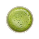 Matcha tea in a bowl with a frothy green surface viewed from above.