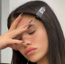 Young woman covering her face with her hand in a gesture of annoyance or disbelief.